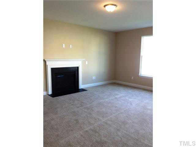 3513 Eastern Branch Road Raleigh, NC 27610 - Photo 3 of 14 a view of an empty room with a fireplace
