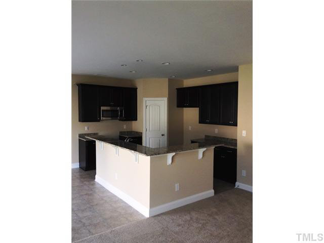 3513 Eastern Branch Road Raleigh, NC 27610 - Photo 5 of 14 a kitchen with stainless steel appliances granite countertop a sink and a refrigerator