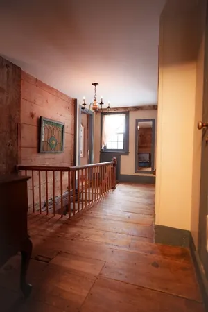 a view of gallery with wooden floor