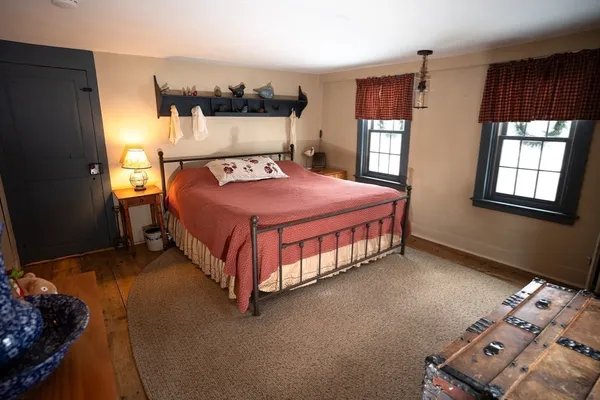 a bed sitting in a bedroom next to a window