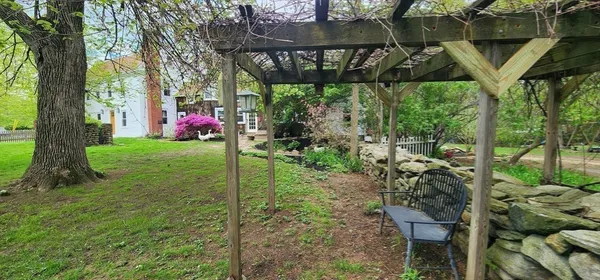 a view of a backyard with table and chairs and potted plants