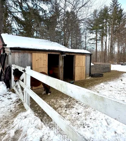 a view of a house with a wooden fence