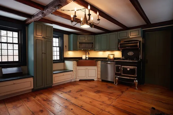 a kitchen with granite countertop wooden cabinets and a stainless steel appliances