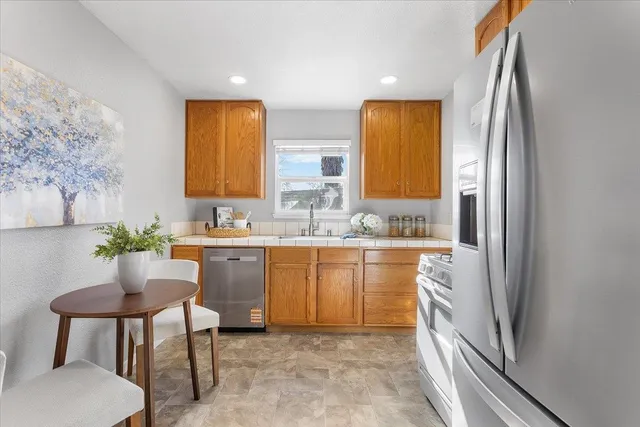 a spacious bathroom with a granite countertop sink and a mirror