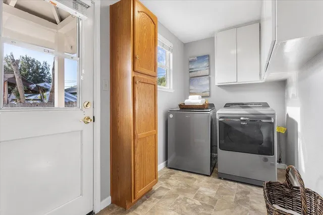 a kitchen with stainless steel appliances granite countertop a refrigerator a sink a stove and white cabinets