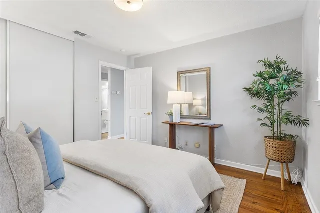 a bedroom with a bed and a potted plant