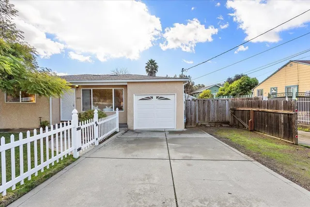 a view of a house with wooden fence
