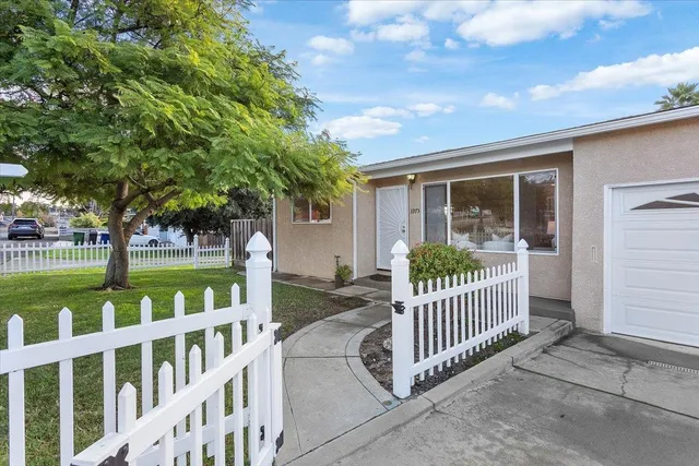 a view of a house with backyard and deck