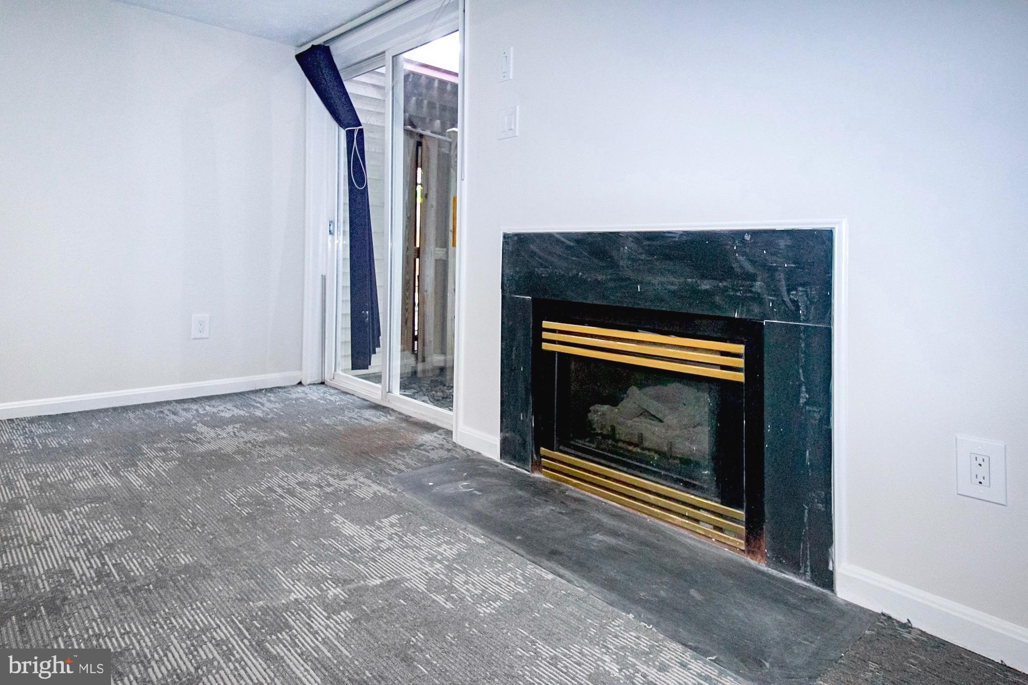 8302 Singleton Terrace Manassas, VA 20109 - Photo 21 of 26 Lower Family Room Fireplace and walk-out to backya