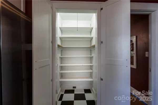 a black and white checkered floor with a black white checkered floor next to a window