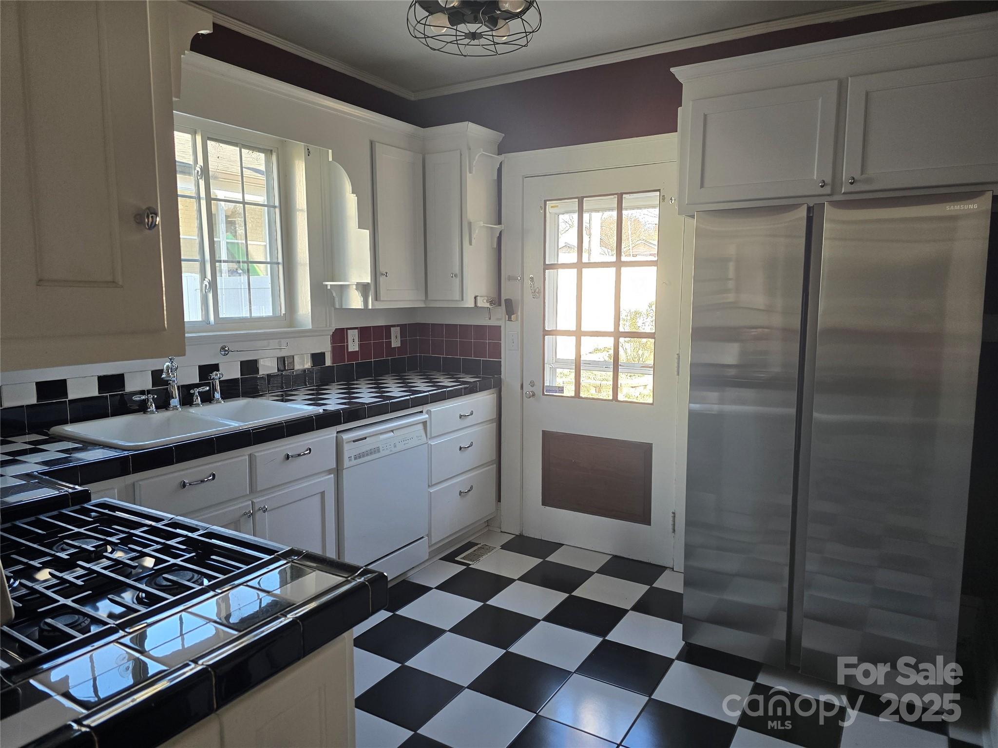 274 North 4th Street Albemarle, NC 28001 - Photo 12 of 44 a kitchen with a checkered floor and a window