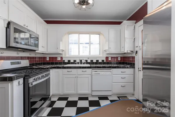 a view of a room with wooden floor and a window