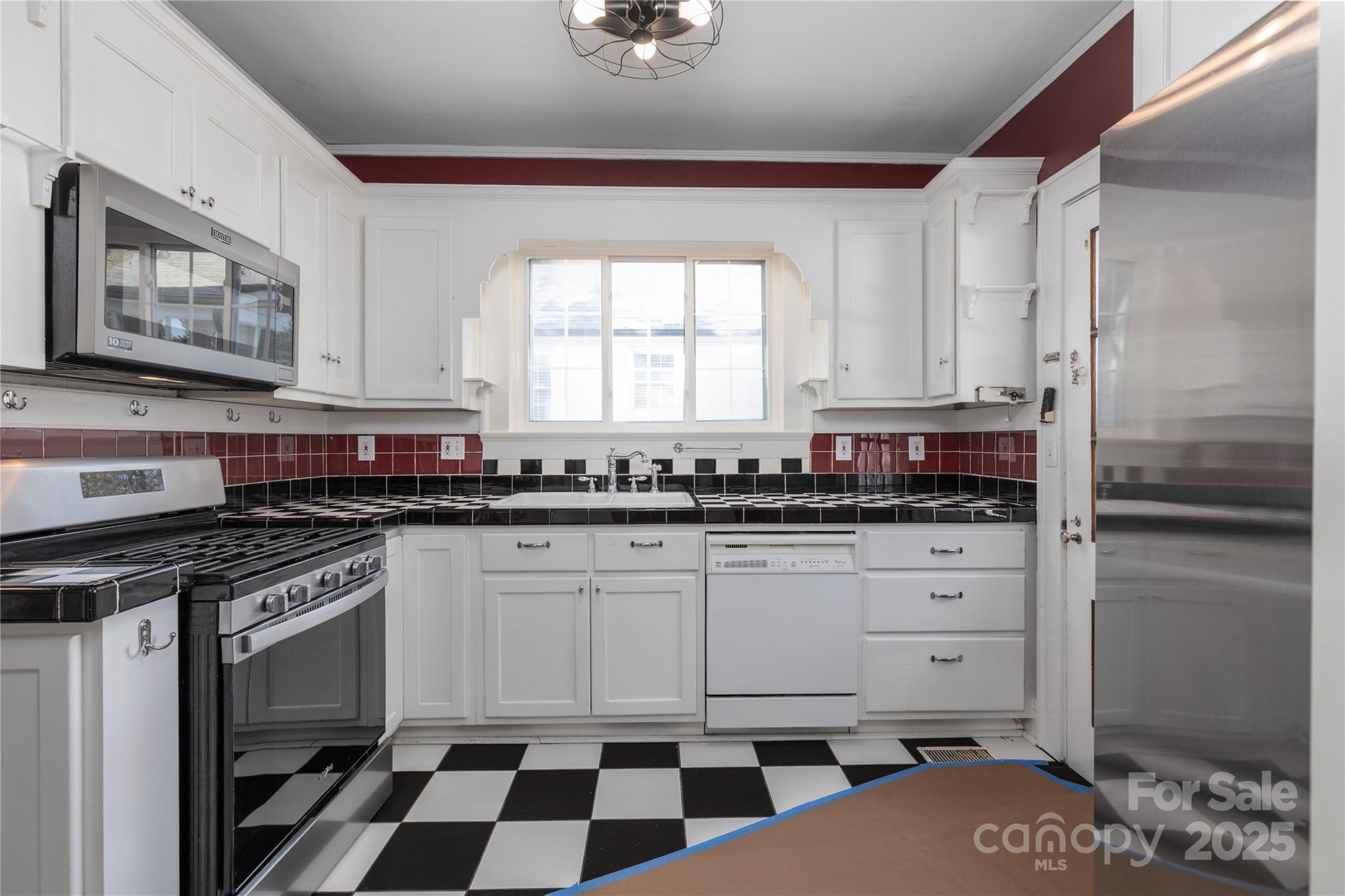 274 North 4th Street Albemarle, NC 28001 - Photo 13 of 44 a kitchen with a stove a sink and a refrigerator