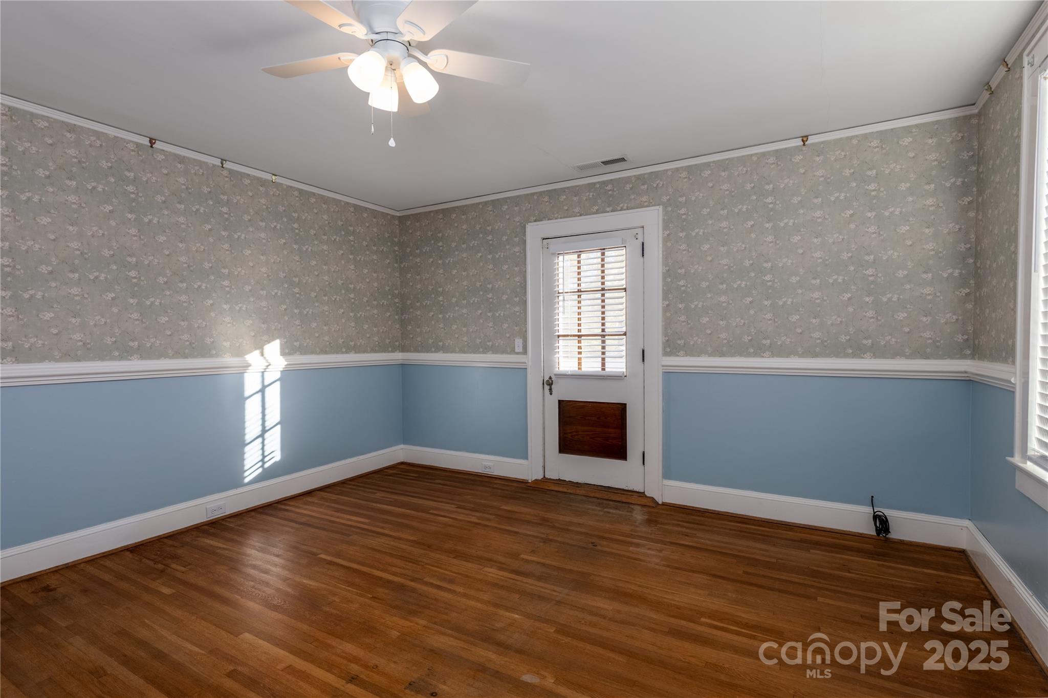 274 North 4th Street Albemarle, NC 28001 - Photo 32 of 44 a view of empty room with wooden floor and fan