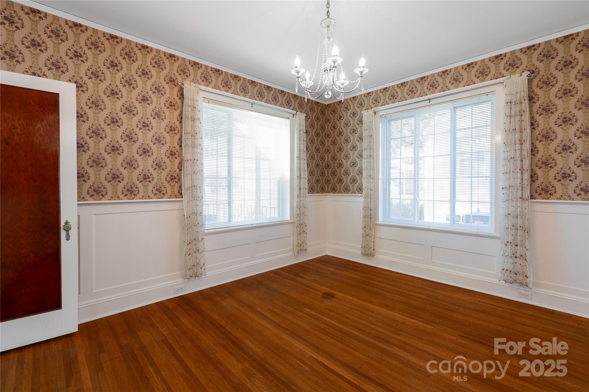 274 North 4th Street Albemarle, NC 28001 - Photo 9 of 44 a view of an empty room with wooden floor and a window