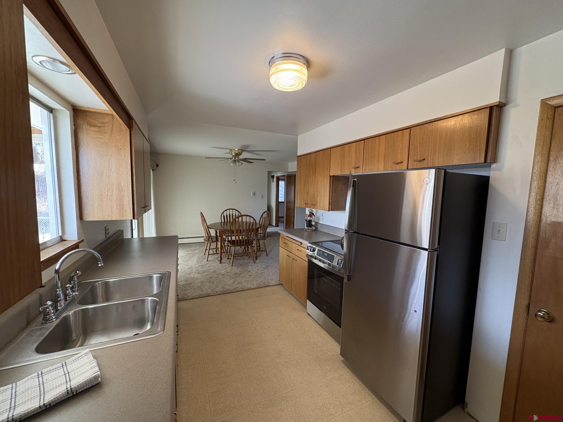 640 East 3rd Street Delta, CO 81416 - Photo 11 of 31 a kitchen with refrigerator and furniture