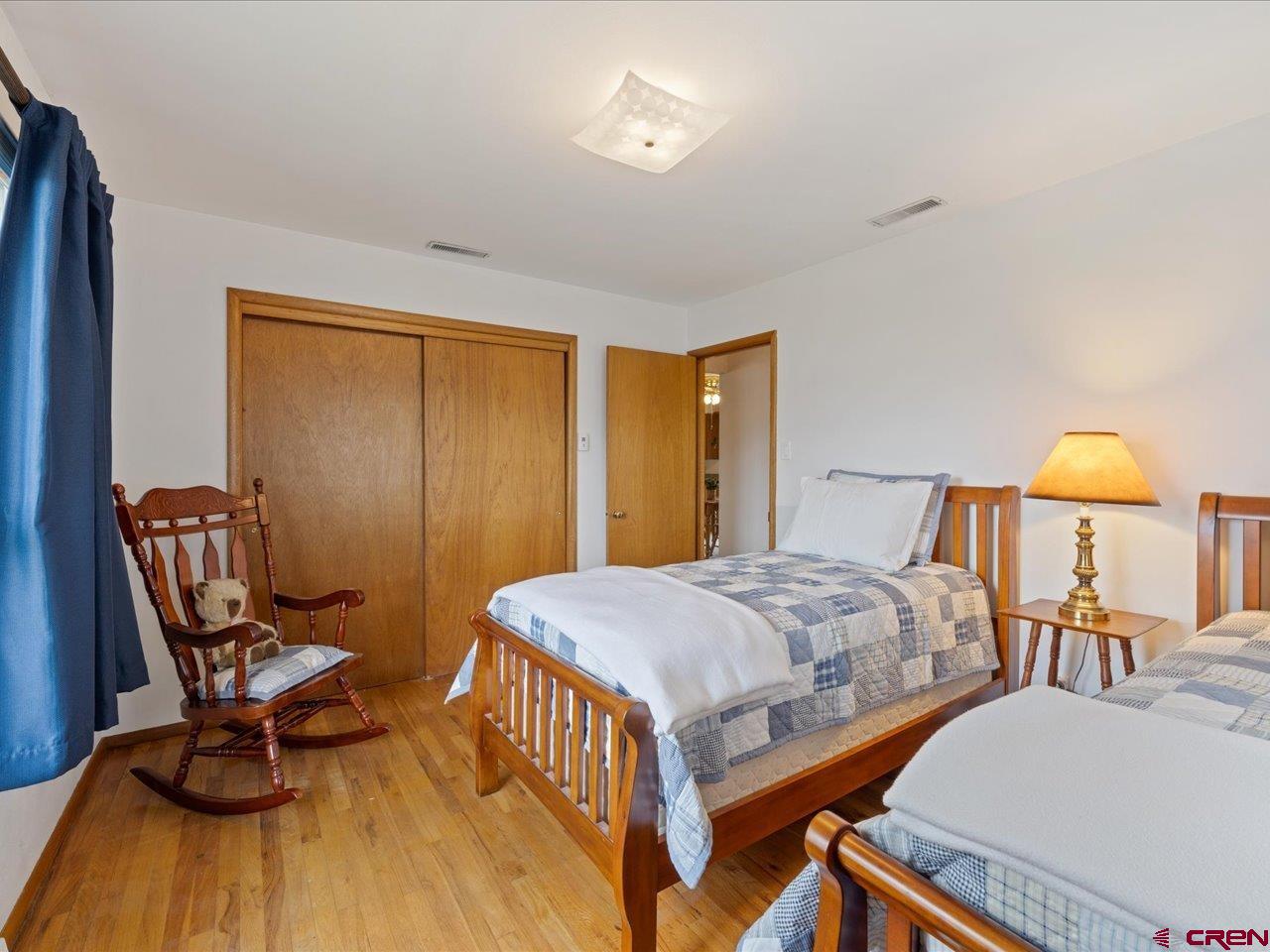 640 East 3rd Street Delta, CO 81416 - Photo 14 of 31 a bedroom with a bed and wooden floor