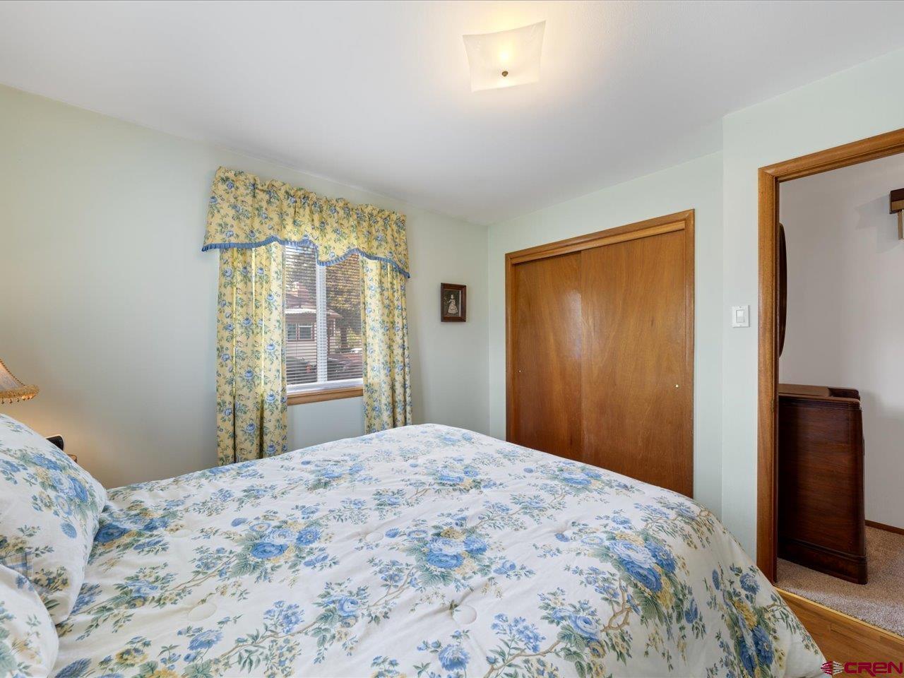 640 East 3rd Street Delta, CO 81416 - Photo 17 of 31 a bedroom with a bed and a large window