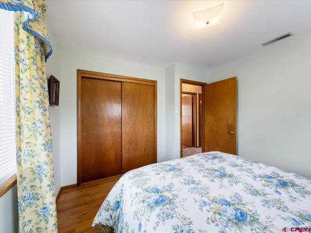 a bedroom with a bed and a curtain