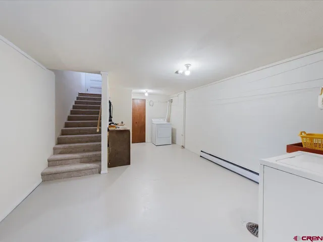 a view of an empty room with stairs and ventilation