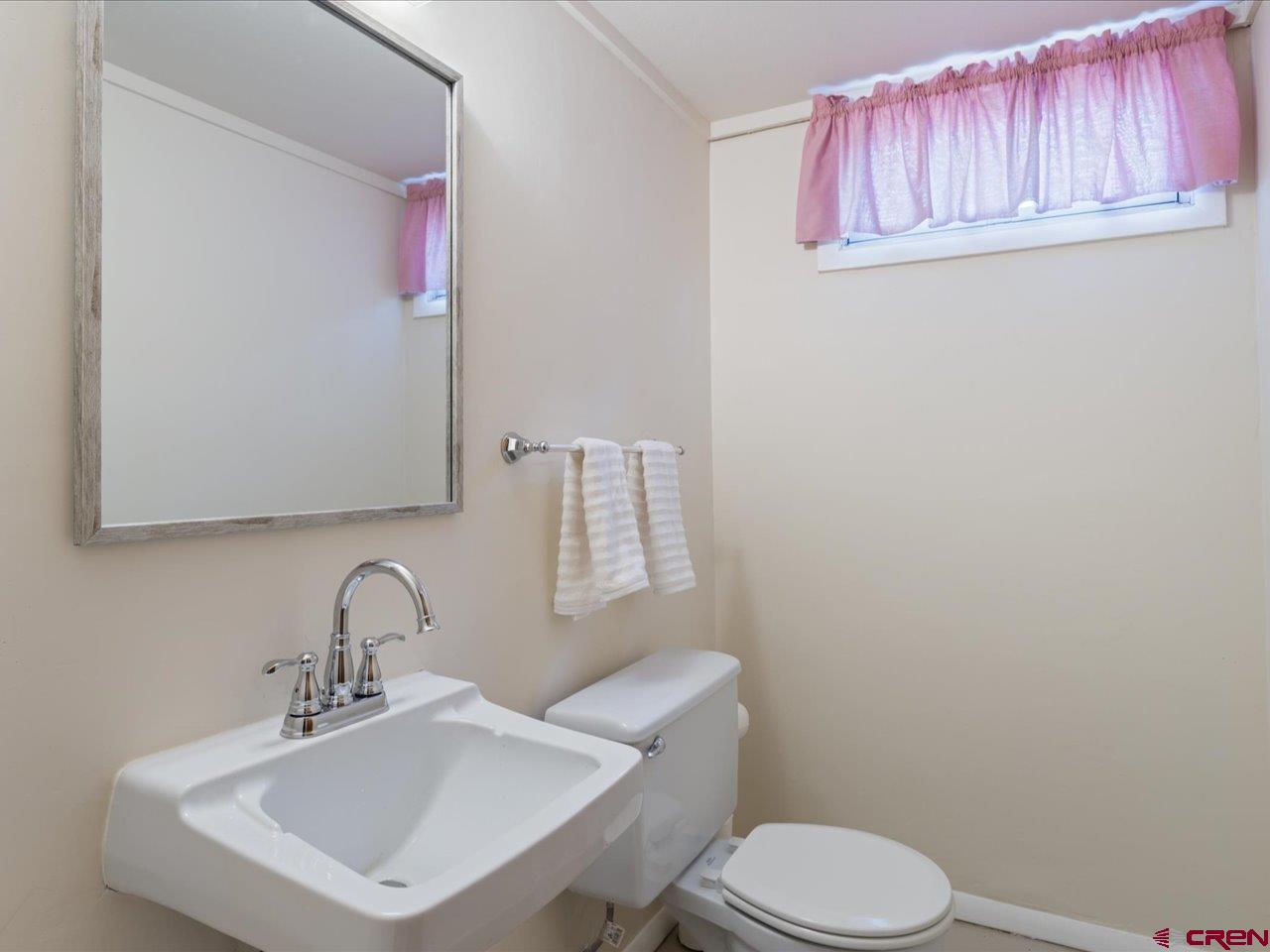 640 East 3rd Street Delta, CO 81416 - Photo 25 of 31 a bathroom with a sink mirror and toilet
