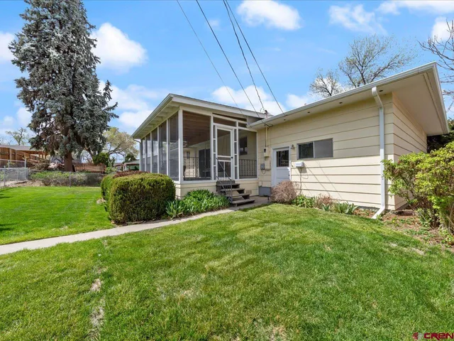 a front view of house with yard and green space