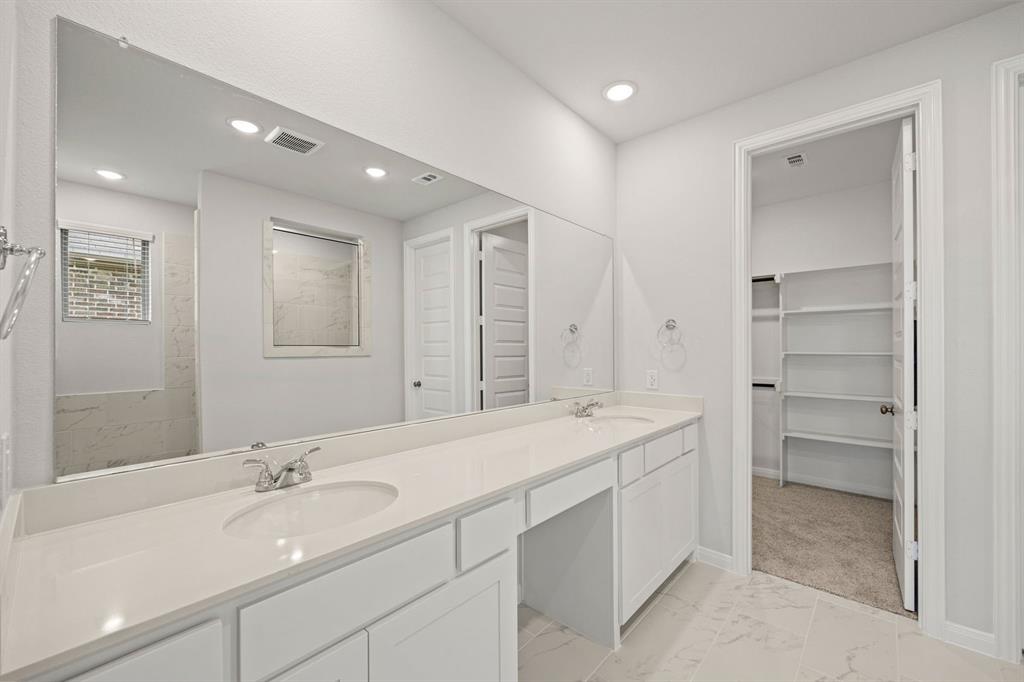 1506 Red Clover Avenue Van Alstyne, TX 75495 - Photo 14 of 24 a bathroom with a sink double vanity and a mirror