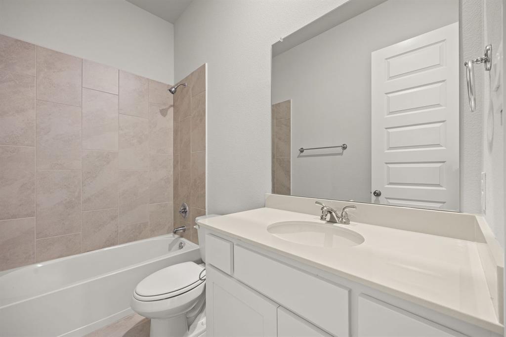 1506 Red Clover Avenue Van Alstyne, TX 75495 - Photo 20 of 24 a bathroom with a sink toilet and shower