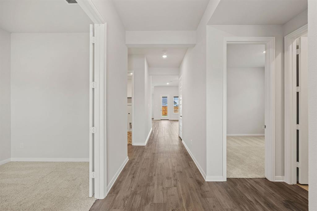 1506 Red Clover Avenue Van Alstyne, TX 75495 - Photo 22 of 24 a view of a hallway with wooden floor