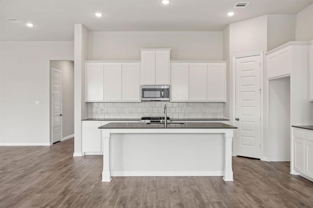 1506 Red Clover Avenue Van Alstyne, TX 75495 - Photo 3 of 24 a kitchen with stainless steel appliances granite countertop a stove and a refrigerator