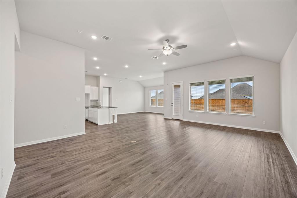 1506 Red Clover Avenue Van Alstyne, TX 75495 - Photo 5 of 24 a view of empty room with wooden floor and window