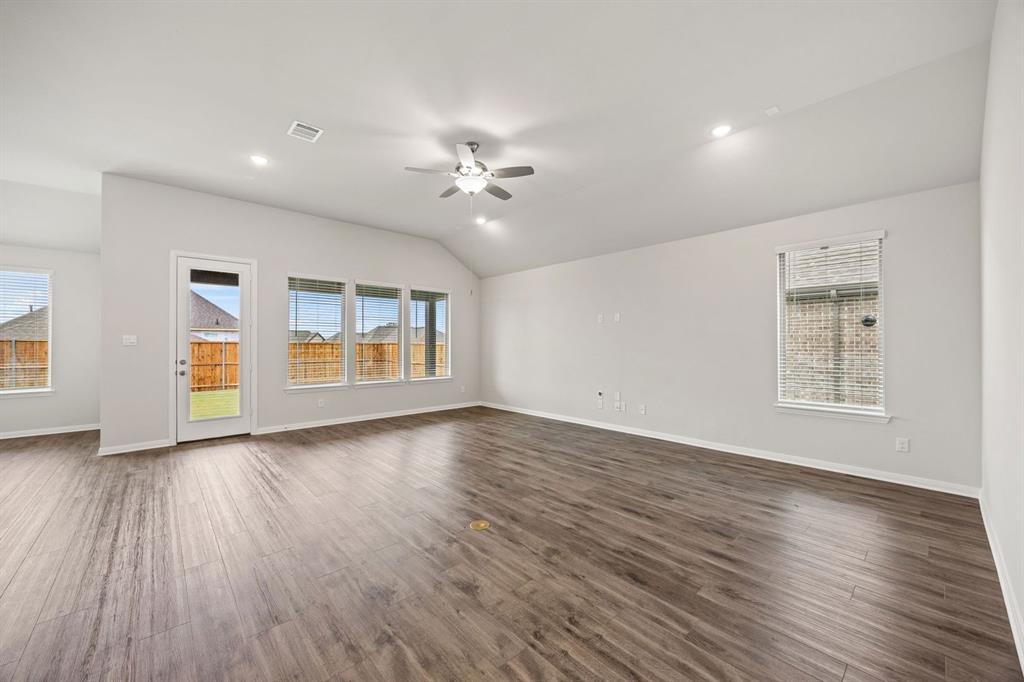 1506 Red Clover Avenue Van Alstyne, TX 75495 - Photo 6 of 24 a view of an empty room with a window and wooden floor
