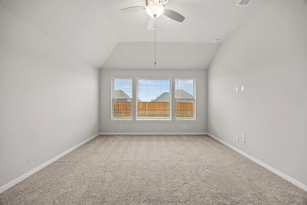 1506 Red Clover Avenue Van Alstyne, TX 75495 - Photo 9 of 24 an empty room with a chandelier fan and windows