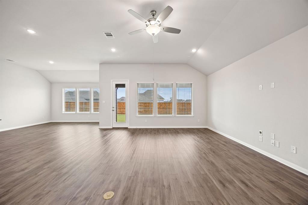 1506 Red Clover Avenue Van Alstyne, TX 75495 - Photo 10 of 24 an empty room with wooden floor and windows