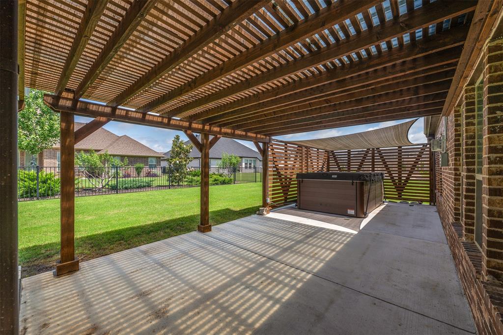 2011 Spieth Street Granbury, TX 76048 - Photo 27 of 35 Fenced backyard featuring a hot tub, a patio, and a pergola
