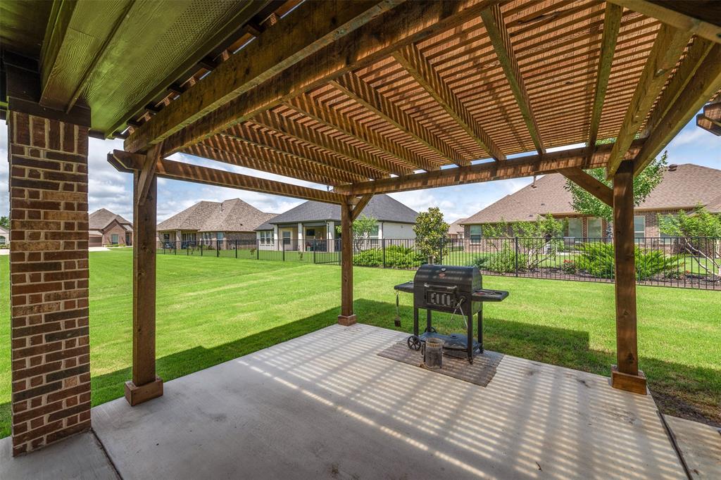 2011 Spieth Street Granbury, TX 76048 - Photo 28 of 35 Fenced backyard with a patio, a pergola, area for grilling, and a residential view