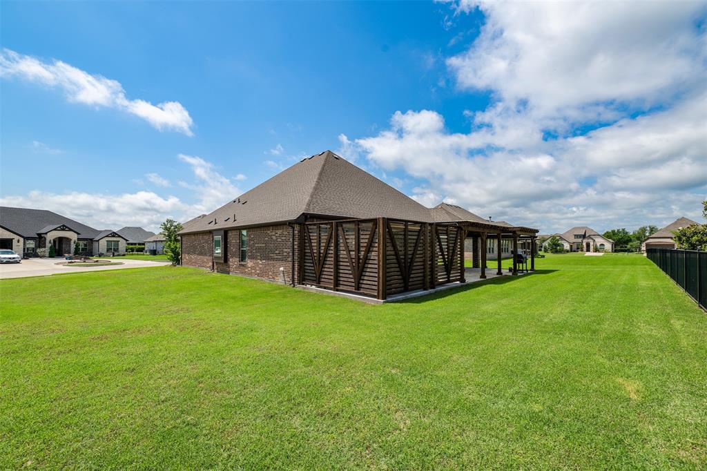 2011 Spieth Street Granbury, TX 76048 - Photo 33 of 35 View of grassy yard with a residential view