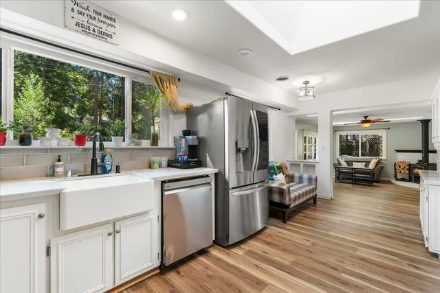 a kitchen with white cabinets and stainless steel appliances