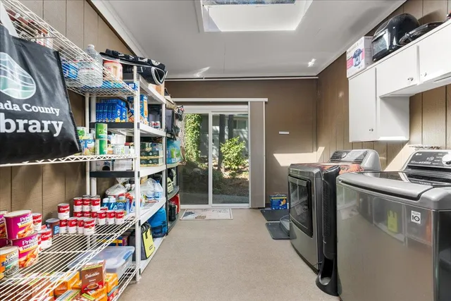 a view of a house with a yard and large tree