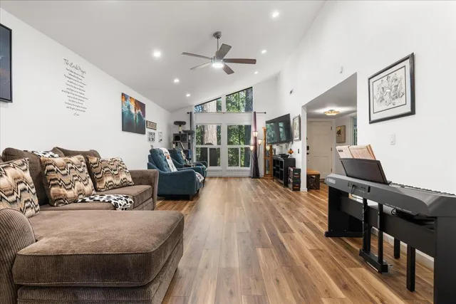 a living room with furniture and a wooden floor