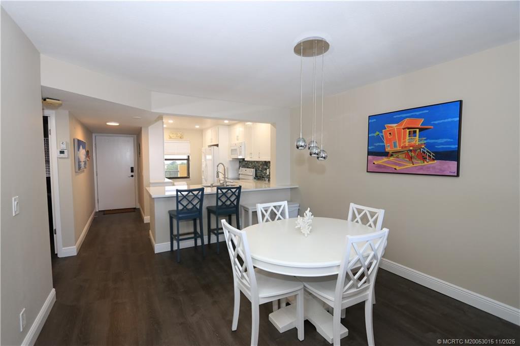7380 South Ocean Drive, Unit 621 Jensen Beach, FL 34957 - Photo 11 of 48 a view of a dining room with furniture and wooden floor