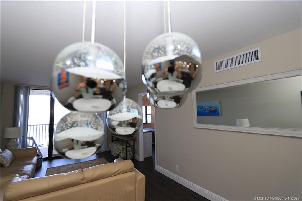 7380 South Ocean Drive, Unit 621 Jensen Beach, FL 34957 - Photo 13 of 48 a view of a dining room with furniture and chandelier