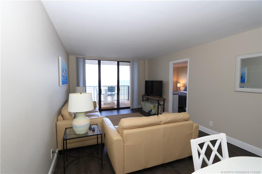 7380 South Ocean Drive, Unit 621 Jensen Beach, FL 34957 - Photo 16 of 48 a living room with furniture and a flat screen tv