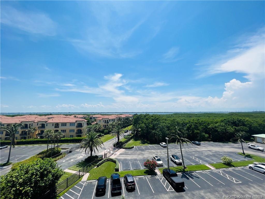 7380 South Ocean Drive, Unit 621 Jensen Beach, FL 34957 - Photo 35 of 48 a view of a swimming pool with lawn chairs under an umbrella
