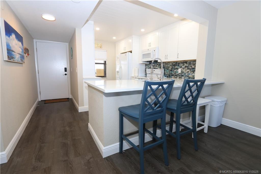 7380 South Ocean Drive, Unit 621 Jensen Beach, FL 34957 - Photo 10 of 48 a view of a dining room with furniture and wooden floor