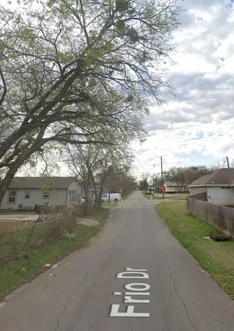 a view of a city street with a yard
