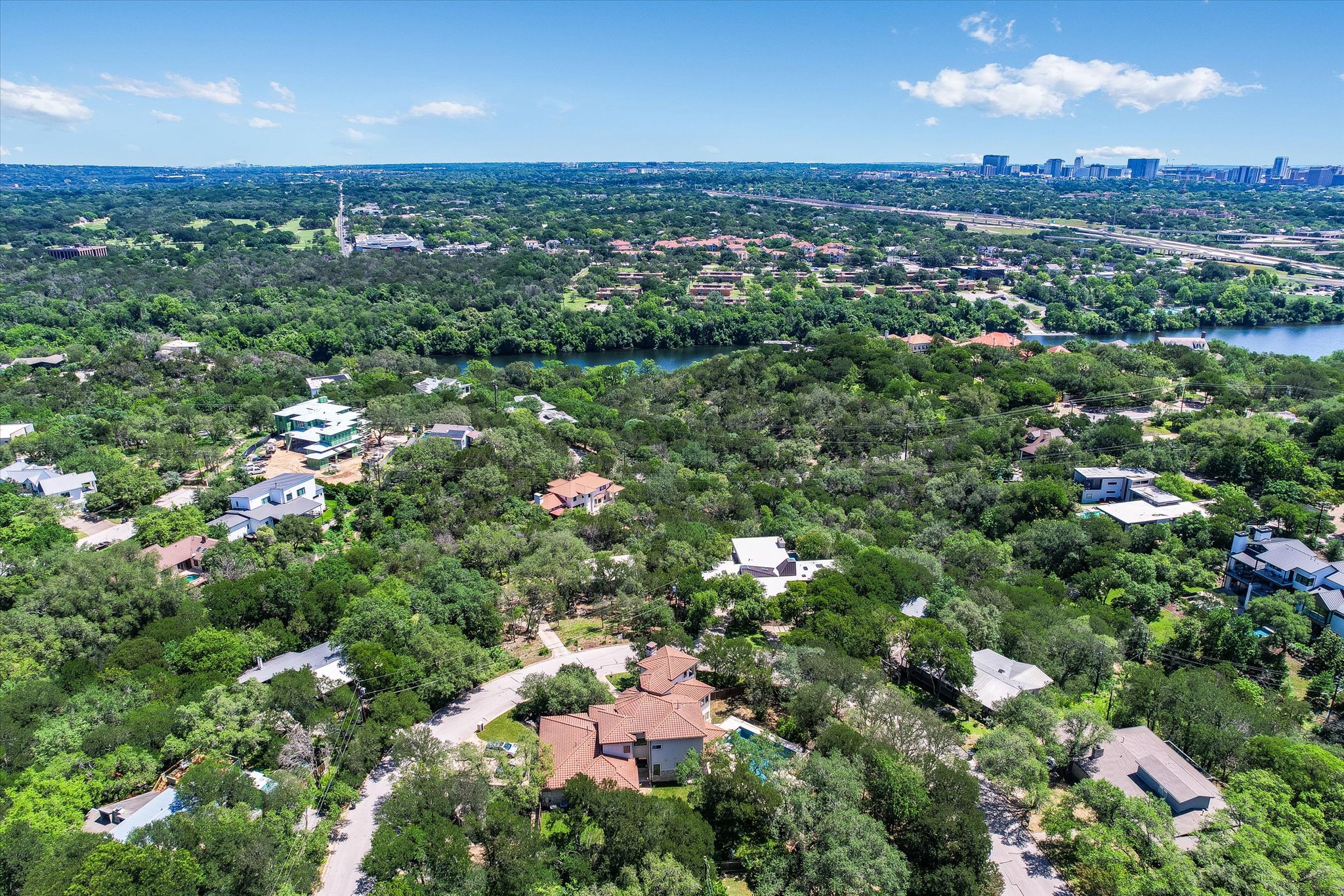 11 Inwood Circle Austin, TX 78746 - Photo 38 of 38 Discover a tranquil lakeside community with abundant greenery and cityscape views.