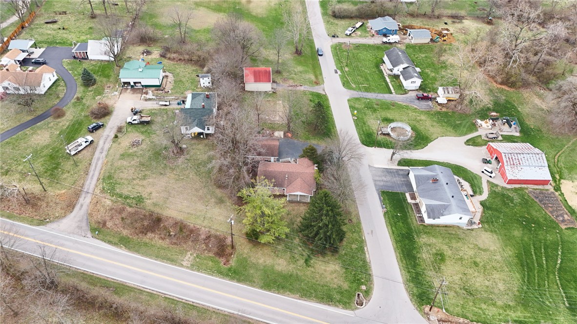 6711 Hamilton-Middletown Road Franklin, OH 45005 - Photo 38 of 49 An aerial view captures a serene neighborhood nestled among lush greenery and winding roads.