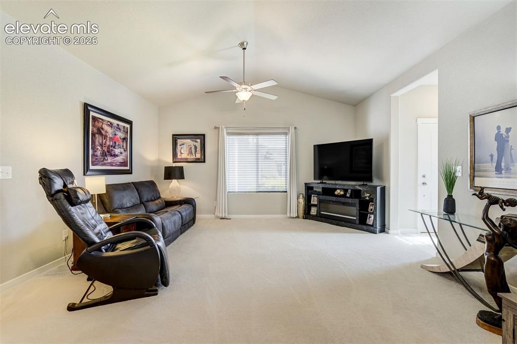 11321 Method Point Peyton, CO 80831 - Photo 7 of 47 Large, bright living room with vaulted ceilings