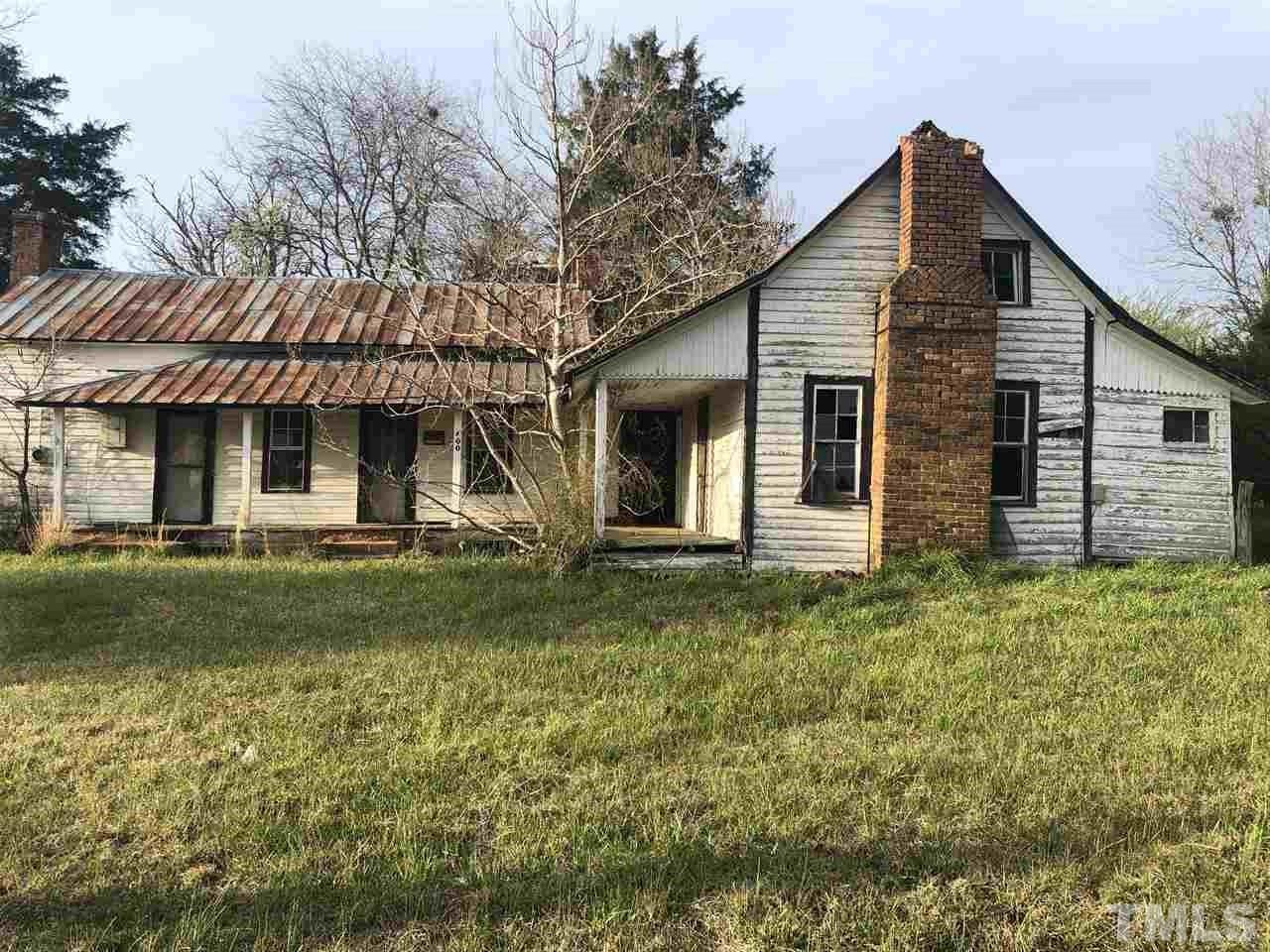 400 Lanes Mill Road Bennett, NC 27208 - Photo 2 of 6 a front view of a house with a garden
